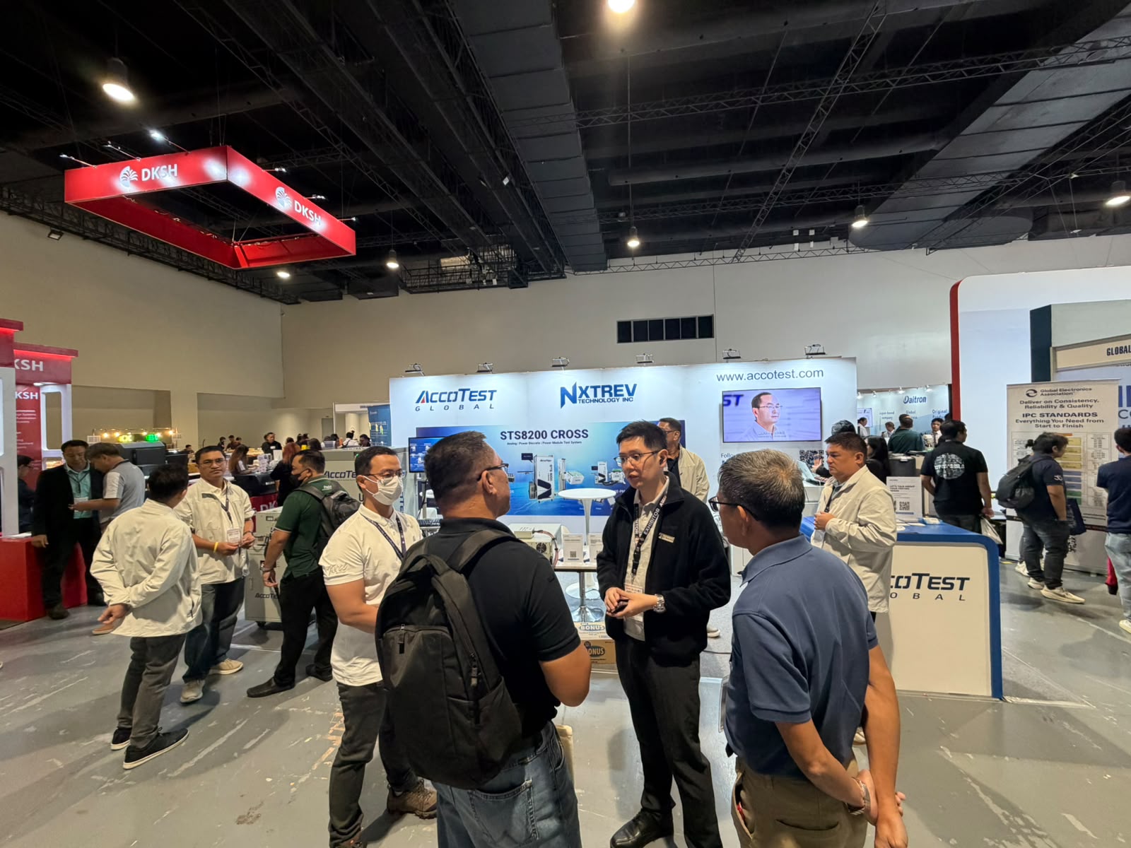 Conversations on semiconductor power test solutions between visitors and the NXTREV and AccoTEST Global teams.