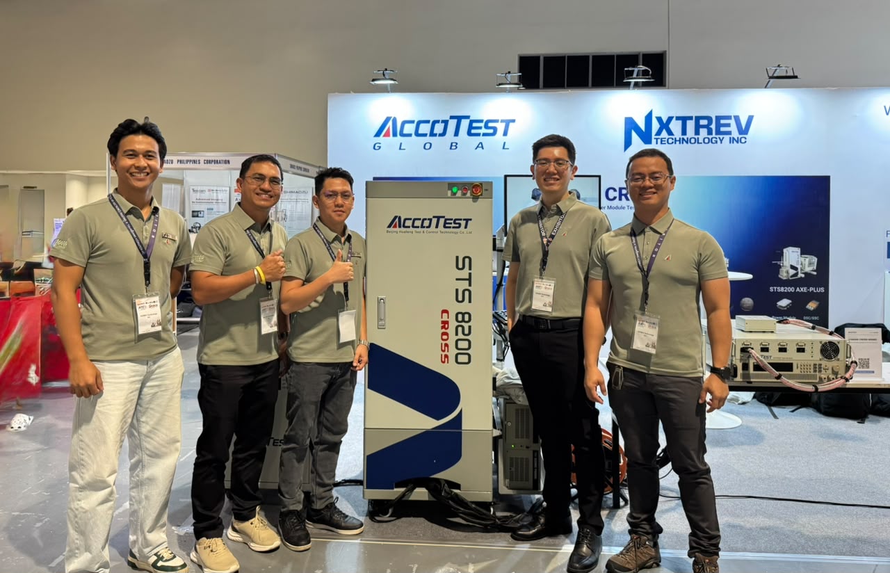 The Philippines team beside the STS8200 CROSS, the scalable tester at the heart of the booth.